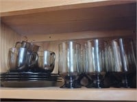 Charcoal colored mugs, glasses and plates
