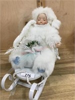 Porcelain doll of sleigh