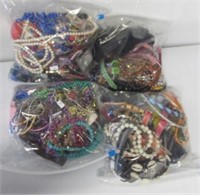 Four large bags of costume jewelry: necklaces,