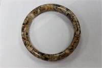 A Lucite Bangle Bracelet With Stones Inside