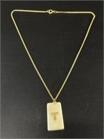Ivory pendant with gold nugget letter "T"