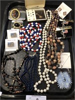 Tray of assorted costume jewelry.