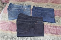Three pairs of jeans one with tags