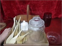 Basket, glass canister, wood spoons, more.
