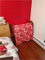 Red Quilt With Quilt Rack