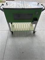 Like green/ stainless cooler on wheels