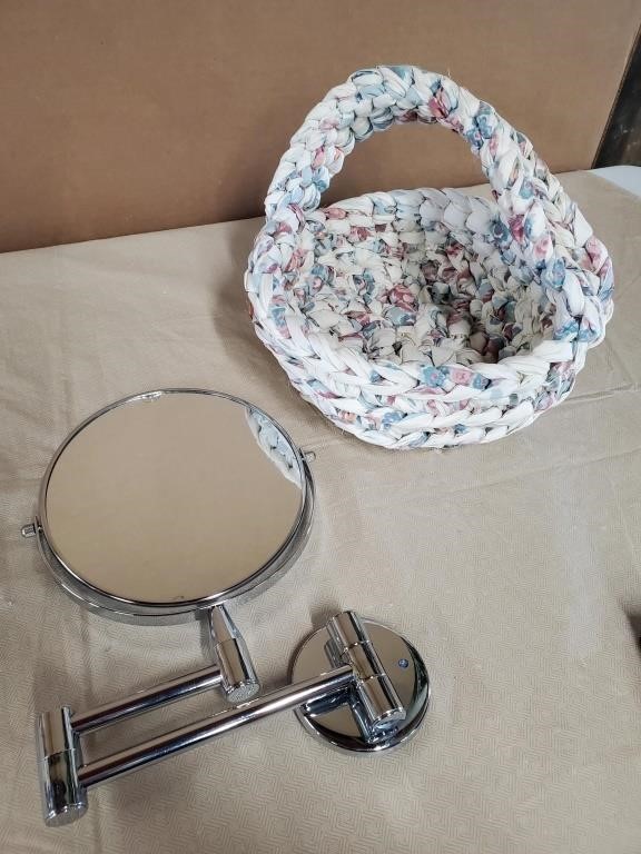 2 sided magnifying mirror that hangs on wall. Has
