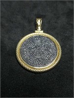 Gold pendant marked 18K weighs approximately 6.1
