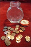Vintage glass clock bank w/ pennies.