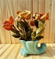 Early plastic? flowers in light teal cornucopia