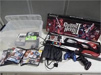 PlayStation with games, controllers and guitar