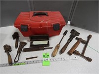 Plastic toolbox with antique pipe wrenches, lug wr