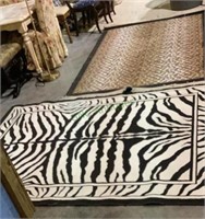 Two safari themed rugs - zebra rug measures 91