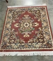 Smaller area rug with fringe measures 64 x 49 -