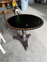 Antique claw-foot table with some damage