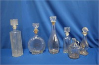 Five decanters, 12.5" down to 8.75" and a jug