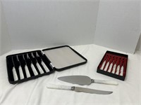 13 stainless steel knives and 1 cake knife by