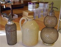 Two soda syphons and a demijohn