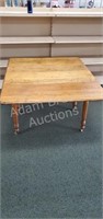 Antique solid oak drop leaf table in casters, 42
