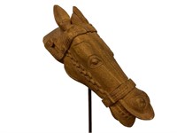 Decorative carved wooden horse head on iron stand