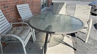 52” round glass top outdoor table and 4 nice