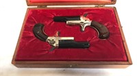 Matching pair of miniature colt 22 caliber