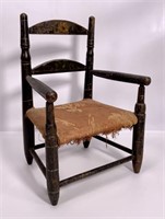 Decorated child's chair, ladder back, arms are