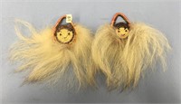 A pair of wall hanging dancing fans made of grass