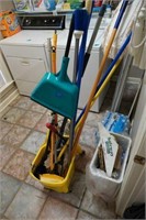 mop bucket with assorted mops and brooms