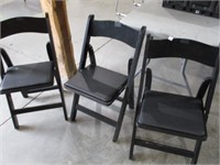 wooden folding chairs .