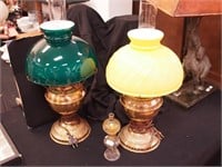 Two brass oil lamps with glass shades, one