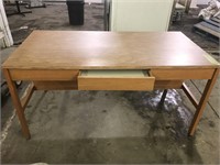 Long wooden desk with centre drawer. Approx. 60?