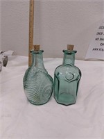 Two blue glass bottles with corks