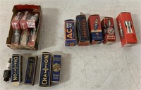 lot of spark plugs and boxes