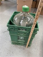 Large 5 gallon glass water jug with green crate