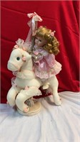 Girl doll on carousel horse