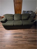 Green Lazy Boy couch in basement bring lifting
