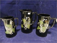 3 VICTORIAN ENGLISH BLACK PAINTED PITCHERS