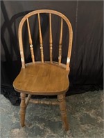 Oak dining chair has some white paint on it