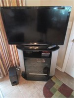 flat screen tv,stand,dvd player,speakers & items