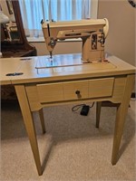 Singer sewing machine with table.