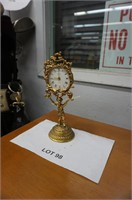 old brass figural alarm clock with young boy