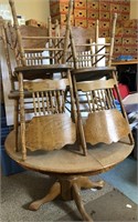 Round wood table, 4 chairs, shows wear