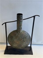 Metal vase decor measures 14 inches on stand