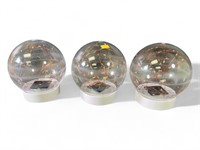 Three solar powered LED lighted globes