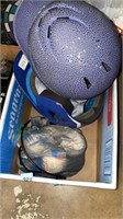 Baseballs and two baseball helmets