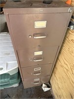 four drawer, metal filing cabinet full of tools