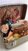 Train case of millinery flowers, fabric, trim