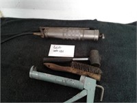 Grease gun, wire brush, rubber hammer and