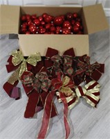 Assortment of red Christmas tree ornaments & bows
